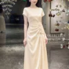 Váy Thiết Kế MDU6633 – Twist Satin Kem, Phối Hoa Thủ Công Đính Eo 10 Dress model in outfit 4K 202607151428 2 11zon Mdu Fashion